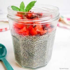 fast chia seed pudding in a glass jar, topped with strawberries