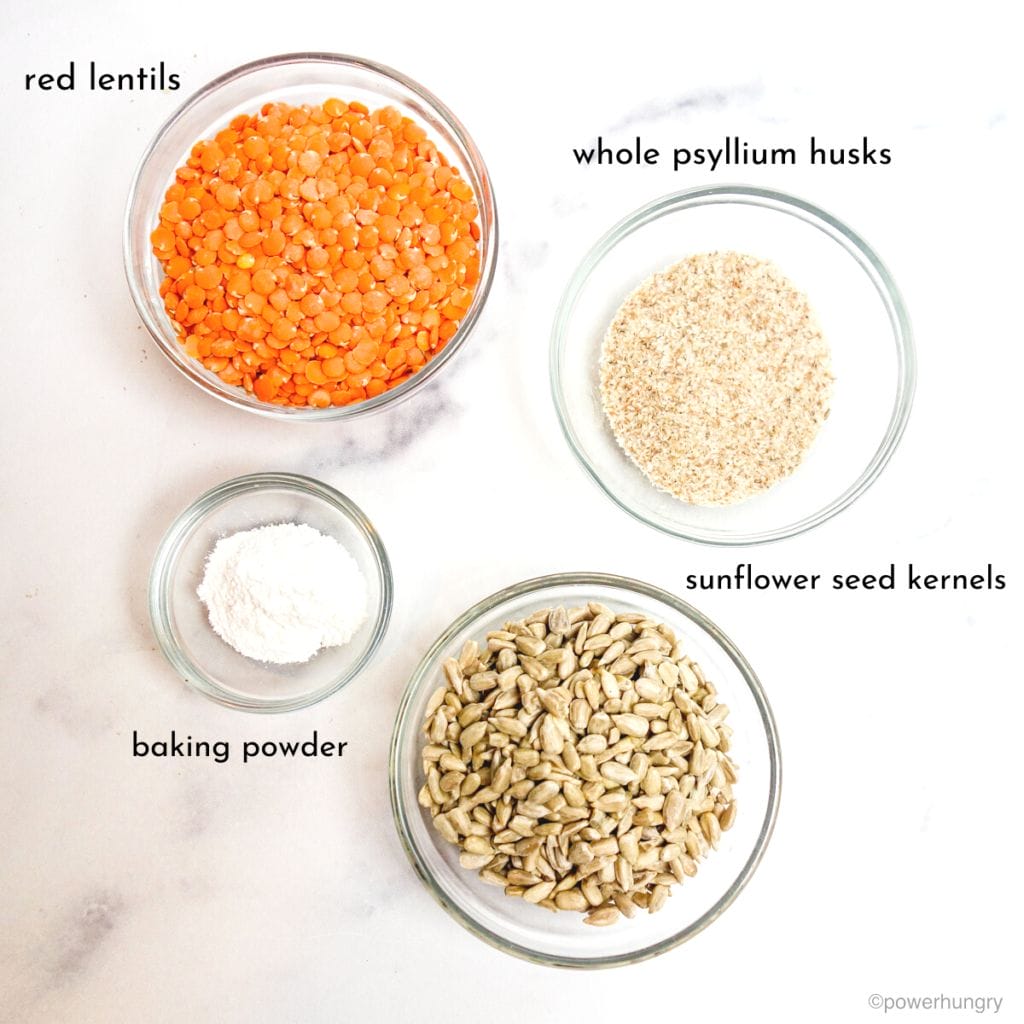 clear glass bowls on a marble counter, all filled with ingredients for red lentil bread