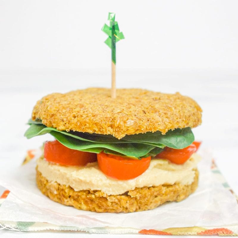 a mini sandwich made with flax brea, hummus, and vegetables