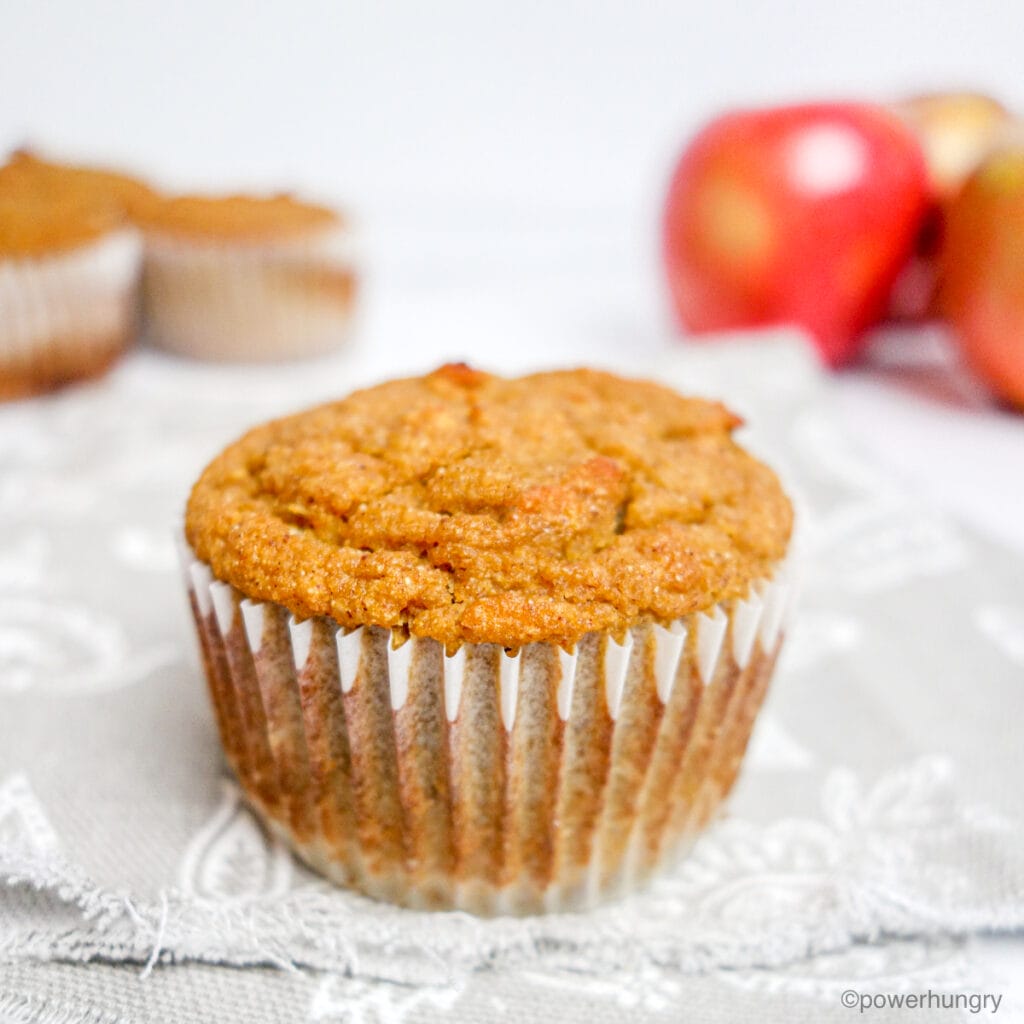 a single applesauce muffin on a gray and white napkin