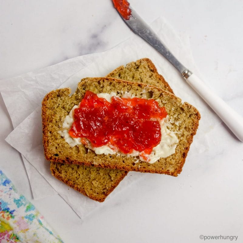 slices of oat flour soda bread with strawberry jam spread on top