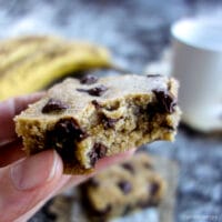 an oil-free vegan banana blondie with a bite taken out of it
