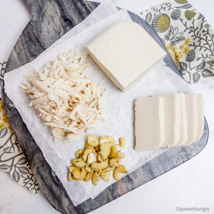 grey marble cutting board with cashew mozzarella cheese on top